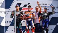 (FromL) Second-placed Petronas Yamaha SRT French rider, Fabio Quartararo, race winner Repsol Honda Team Spanish rider, Marc Marquez, third-placed Monster Energy Yamaha Spanish rider, Maverick Vinales (R) celebrate on the podium along with a Repsol Honda t