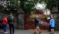 Visitors look at the gates to Strawberry Field in Liverpool, northwest England on September 18, 2019. AFP / Paul Ellis
 