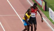 Aruba's Jonathan Busby is helped to the finish line by Guinea-Bissau's Braima Suncar Dabo REUTERS/Ahmed Jadallah 