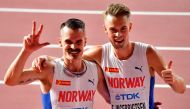 Norway's Henrik Ingebrigtsen (L) and Norway's Filip Ingebrigtsen celebrate after the Men's 5000m heats at the 2019 IAAF World Athletics Championships at the Khalifa International stadium in Doha on September 27, 2019. / AFP / Giuseppe CACACE