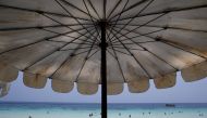 Tourists are seen on a beach in Phuket, Thailand March 18, 2016. Reuters/Athit Perawongmetha