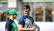 Ireland's head coach Joe Schmidt (L) speaks with Ireland's fly-half Jonathan Sexton at a training session at the Steelers Training Ground in Kobe on October 1, 2019, during the Japan 2019 Rugby World Cup. / AFP / Filippo Monteforte 