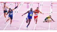 USA’s Grant Holloway (centre) wins the  men’s 110 hurdles final as Jamaica’s Omar Mcleod (right) lies on the track. Picture: Abdul basit / The Peninsula