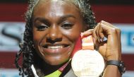 Gold medallist Britain's Dina Asher-Smith poses on the podium during the medal ceremony for the Women's 200m at the 2019 IAAF World Athletics Championships in Doha on October 3, 2019. / AFP / KARIM JAAFAR 