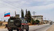 Russian military police vehicles drive in a joint patrol with the Syrian Kurdish Asayish internal security forces in the town of Kobane, also known as Ain al-Arab, in the north of Syria's Aleppo province on October 25, 2019. / AFP / -