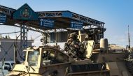 A US soldier sits atop an armoured personnel carrier in the Kurdish-majority city of Qamishli, in Syria's northeastern Hasakeh province on November 2, 2019. / AFP / Delil SOULEIMAN