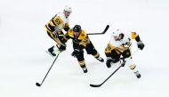 Brad Marchand #63 of the Boston Bruins battles for the puck with Jake Guentzel #59 and Kris Letang #58 of the Pittsburgh Penguins during the first period at TD Garden on November 04, 2019 in Boston, Massachusetts. Tim Bradbury/Getty Images/AFP