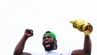 South African Rugby captain Siya Kolisi holds up the Web Ellis Trophy while the South African Rugby World Cup winner team parades on an open top bus through the streets of the city of Zwide , Port Elizabeth, on November 10, 2019. AFP / Wikus De Wet

