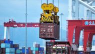 A container is transferred at a port in Qingdao, Shandong province in eastern  China on July 6, 2018. AFP