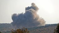 FILE PHOTO: Smoke billows during reported airstrikes by Syrian pro-regime forces on the village of Bsaqla, in the southern countryside of Idlib province, on November 26, 2019. / AFP / Omar HAJ KADOUR