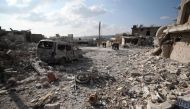 TOPSHOT - Residents check the damage following reported air and helicopter raids by Russian and Syrian regime forces in the town of Al-Bara in the south of Syria's Idlib province on December 7, 2019. / AFP / Omar HAJ KADOUR