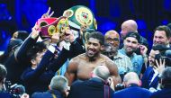 British boxer Anthony Joshua celebrates after winning the heavyweight boxing match between Andy Ruiz Jr. and Anthony Joshua for the IBF, WBA, WBO and IBO titles in Diriya, near the Saudi capital on December 7, 2019. AFP / Fayez Nureldine