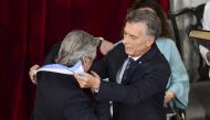 Argentina's incoming president Alberto Fernandez (L) receives the presidential sash from outgoing president Mauricio Macri .December 10, 2019. / AFP / Ronaldo SCHEMIDT

