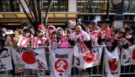 Fans gather in the street to watch a parade by the Japan rugby squad in Tokyo's Marunouchi business district on December 11, 2019 as part their Japan 2019 Rugby World Cup campaign. / AFP / Kazuhiro NOGI