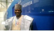 Nigerian Environment Minister Mohammad Mahmood Abubakar poses for a picture in front of his country's office at the U.N. climate conference in Madrid, December 11, 2019. Thomson Reuters Foundation/Megan Rowling