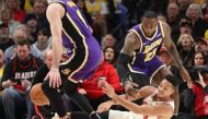 Portland Trail Blazers guard CJ McCollum (3) loses the ball as Los Angeles Lakers forward LeBron James (23) defends in the second half at Moda Center. Jaime Valdez