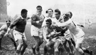 In this file photograph taken on February 23, 1957, France's captain Michel Celaya (C) is tackled by England's players during the Five Nations rugby union tournament match between England and France at Twickenham, west London.  AFP / Intercontinentale / S