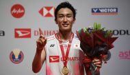 Japan's Kento Momota poses with his medal after winning the men's singles final match against Denmark's Viktor Axelsen during the awards presentation at the Malaysia Open badminton tournament in Kuala Lumpur on January 12, 2020. / AFP / Mohd RASFAN
