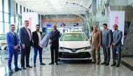 R K Murugan (fourth left), Acting CEO at AAB, handing over the symbolic Toyota key to Nezar Al Merai (third left), General Manager of Global Limousine, at a ceremony in Doha, recently. 