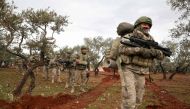 Turkish soldiers gather in the village of Qaminas, about 6 kilometres southeast of Idlib city in northwestern Syria on February 10, 2020.  AFP / Omar HAJ KADOUR