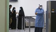 Kuwaitis coming back from Iran wait at Sheikh Saad Airport in Kuwait City, on February 22, 2020, before being taken to a hospital to be tested for coronavirus./ AFP / YASSER AL-ZAYYAT 