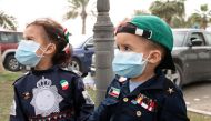 Kuwaiti kids wear protective face masks, following the outbreak of coronavirus, during celebrations of the 29th Kuwait Liberation Day from the Iraqi occupation, in Kuwait February 26, 2020. REUTERS/Stephanie McGehee