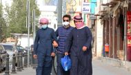 Kuwaiti men, wearing protective masks, shop in Kuwait City on February 26, 2020.  AFP / YASSER AL-ZAYYAT