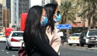 People wear protective masks in Kuwait City on February 27, 2020 amidst a world epidemic of cononavirus COVID-19. AFP / YASSER AL-ZAYYAT