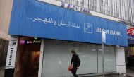 A man walks in front of a bank in the capital Beirut on March 6, 2020. AFP / JOSEPH EID
