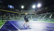 Courtmaster Jeffrey Brooker cleans the center court at the Indian Wells Tennis Garden on March 08, 2020 in Indian Wells, California. The BNP Paribas Open was cancelled by the Riverside County Public Health Department, as county officials declared a public