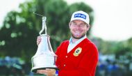 Tyrrell Hatton wears a red alpaca cardigan sweater given to the winner as he holds the champions trophy after winning the Arnold Palmer Invitational golf tournament at Bay Hill Club & Lodge Mar 8, 2020; Orlando, Florida. Credit: Reinhold Matay-USA TODAY S