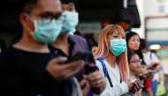 Commuters wait for a transport to leave the Woodlands Causeway across to Singapore from Johor, hours before Malaysia imposes a lockdown on travel due to the coronavirus outbreak March 17, 2020. Reuters/Edgar Su