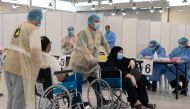 Volunteers help Kuwaitis, arriving from Europe, to do their compulsory testing at a coronavirus testing centre, at the Kuwait International Fairgrounds in Mishref, Kuwait March 18, 2020. REUTERS/Stephanie McGehee