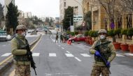 Jordanian army members stand guard at a check point after the start of a nationwide curfew, amid concerns over the coronavirus disease (COVID-19) spread, in Amman, Jordan March 21, 2020. REUTERS/Muhammad Hamed
