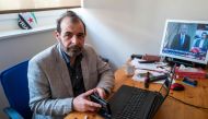 Syrian human rights lawyer Anwar al-Bunni poses in his office in Berlin on April 9, 2020. When Anwar al-Bunni crossed paths with fellow Syrian Anwar Raslan in a DIY store in Germany five years ago, he recognised him as the man who had thrown him into pris