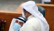 Kuwaiti parliament speaker Marzouq al-Ghanim (L) speaks to MP al-Humaidi al-Subaie during a parliament session at the national assembly in Kuwait City, on June 16, 2020. / AFP / YASSER AL-ZAYYAT