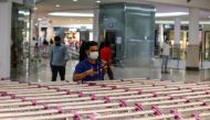 A worker, wearing a face mask, sterilizes shopping carts at a supermarket, following the outbreak of the coronavirus disease (COVID-19) in Riyadh, Saudi Arabia June 14, 2020. REUTERS/Ahmed Yosri