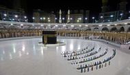 A picture taken June 23, 2020 shows a few worshippers performing al-Fajr prayer at the Kaaba, at the Grand Mosque complex in Saudi Arabia's holy city of Mecca. AFP / STR