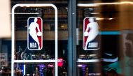 (FILES) In this file photo taken on March 12, 2020, an NBA logo is shown at the 5th Avenue NBA store in New York City. The NBA has settled upon key dates for the upcoming resumption of its coronavirus-halted 2019-20 season, including an October NBA Finals