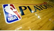 (FILES) In this file photo taken on April 27, 2013, the NBA and Playoffs logo is seen on the court before the game between the Oklahoma City Thunder and Houston Rockets in Houston, Texas. / AFP /  SCOTT HALLERAN
 