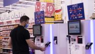 A customer using the self-check out counter.