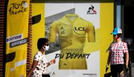 August 26, 2020 A person wearing a protective face mask walks past a merchandise store ahead of the Tour de France REUTERS/Stephane Mahe