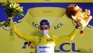 Stage winner Team Deceuninck rider France's Julian Alaphilippe celebrates his overall leader yellow jersey on the podium after winning the 2nd stage of the 107th edition of the Tour de France cycling race, 187 km between Nice and Nice, on August 30, 2020.