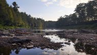 Sunset at Lussier Campsite on the Missisquoi River. Low water exposes rocky shoals along the water's edge. Photo for The Washington Post by Jen Rose Smith