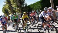 (From R) Team AG2R La Mondiale rider France's Benoit Cosnefroy wearing the best climber's polka dot jersey, Team Ineos rider Colombia's Egan Bernal wearing the best young's white jersey, Team Jumbo rider Slovenia's Primoz Roglic wearing the overall leader