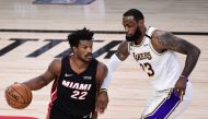 LAKE BUENA VISTA, FLORIDA - OCTOBER 04: Jimmy Butler #22 of the Miami Heat dribbles against LeBron James #23 of the Los Angeles Lakers during the second half in Game Three of the 2020 NBA Finals at AdventHealth Arena at ESPN Wide World Of Sports Complex o