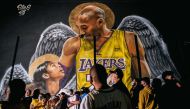 Lakers fans stand in line to celebrate in front of a mural of Kobe Bryant and his daughter Gianna Bryant on October 11, 2020 in Los Angeles, California. People gathered to celebrate after the Los Angeles Lakers defeated the Miami Heat in Game 6 of the NBA