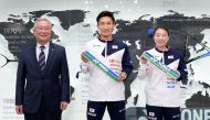 This handout picture released by Yonex on December 9, 2020 shows Japan's badminton world number one Kento Momota (C) poses at a press conference with other participants in Tokyo, after announcing his long-awaited return to competition, nearly a year after