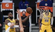 LeBron James #23 of the Los Angeles Lakers scores on a layup over Ivica Zubac #40 of the LA Clippers during a 116-109 LA Clippers win in the season opening game at Staples Center on December 22, 2020 in Los Angeles, California.   Harry How//AFP  
