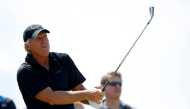 Greg Norman of Australia watches his tee shot on the sixth hole during a practice round ahead of the British Open Golf Championship at the Turnberry Golf Club in Scotland, July 15, 2009. REUTERS/Mike Blake/File Photo